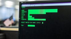 A desktop PC running COBOL computer code, with data input options left blank.