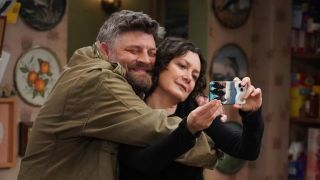 Ben and Darlene taking a selfie together on The Conners