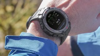 Man's wrist wearing Amazfit T-Rex Pro watch outdoors