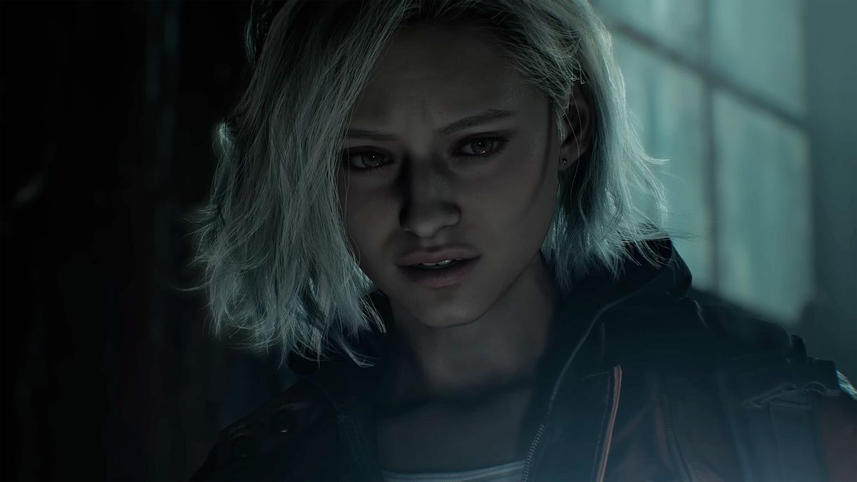 A woman from Resident Evil Requiem with short platinum-colored hair standing in the dark. The shot is close up on her face and she looks frightened.