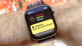Detail shot of an Apple Watch Series 11 showing the steps to set up and send a Check In safety notification in watchOS 26