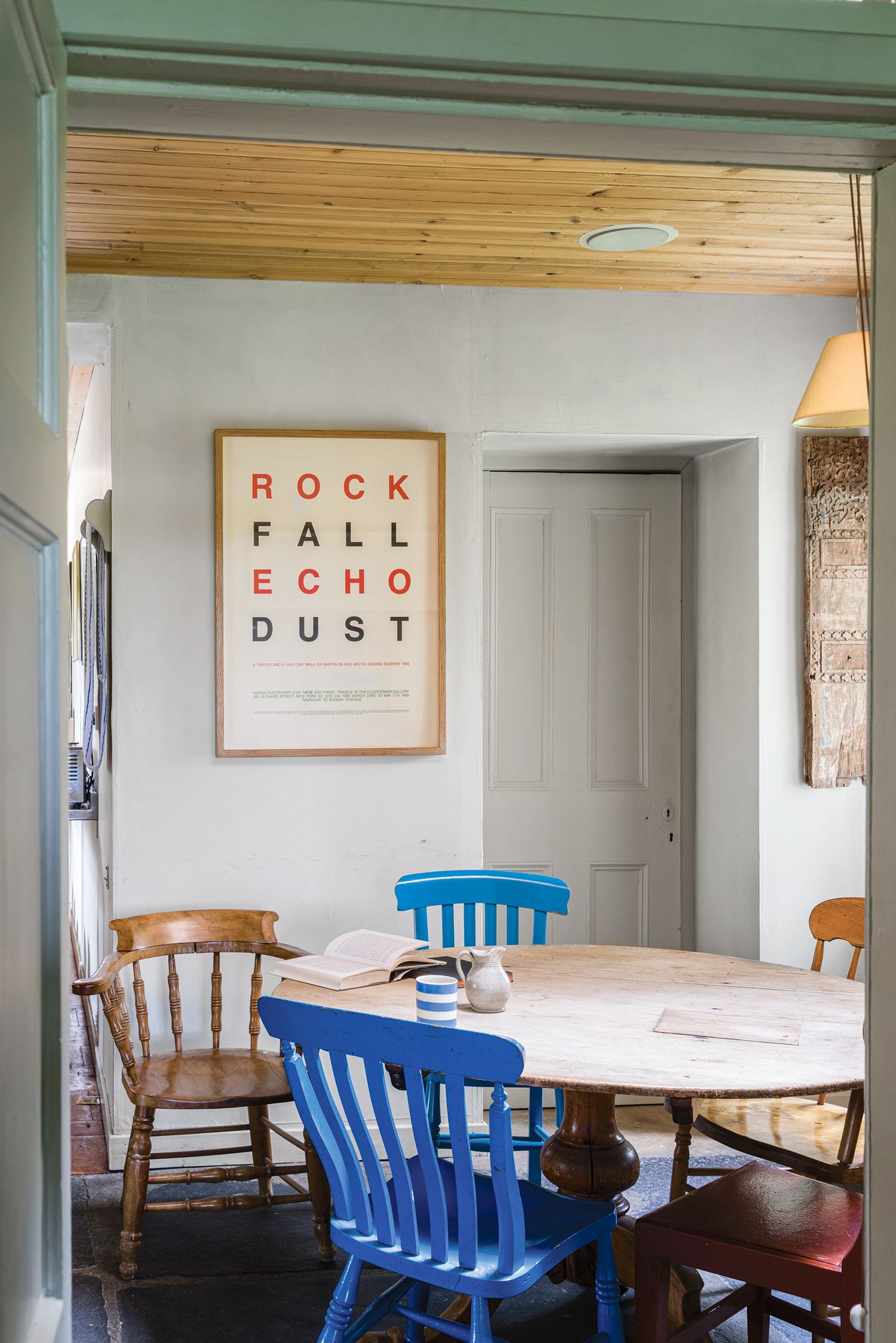 a kitchen with painted dining chairs