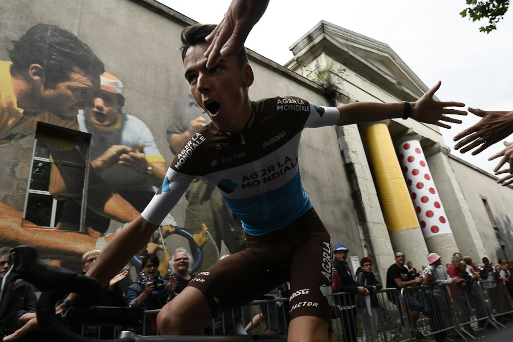 Romain Bardet greets fans on is way to the stage at the 2018 Tour de France team presentation
