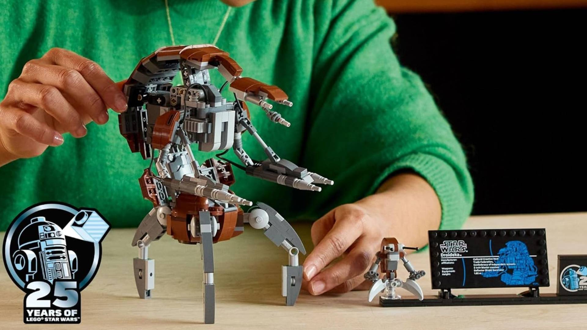 Hand holds Lego Star Wars Droideka model