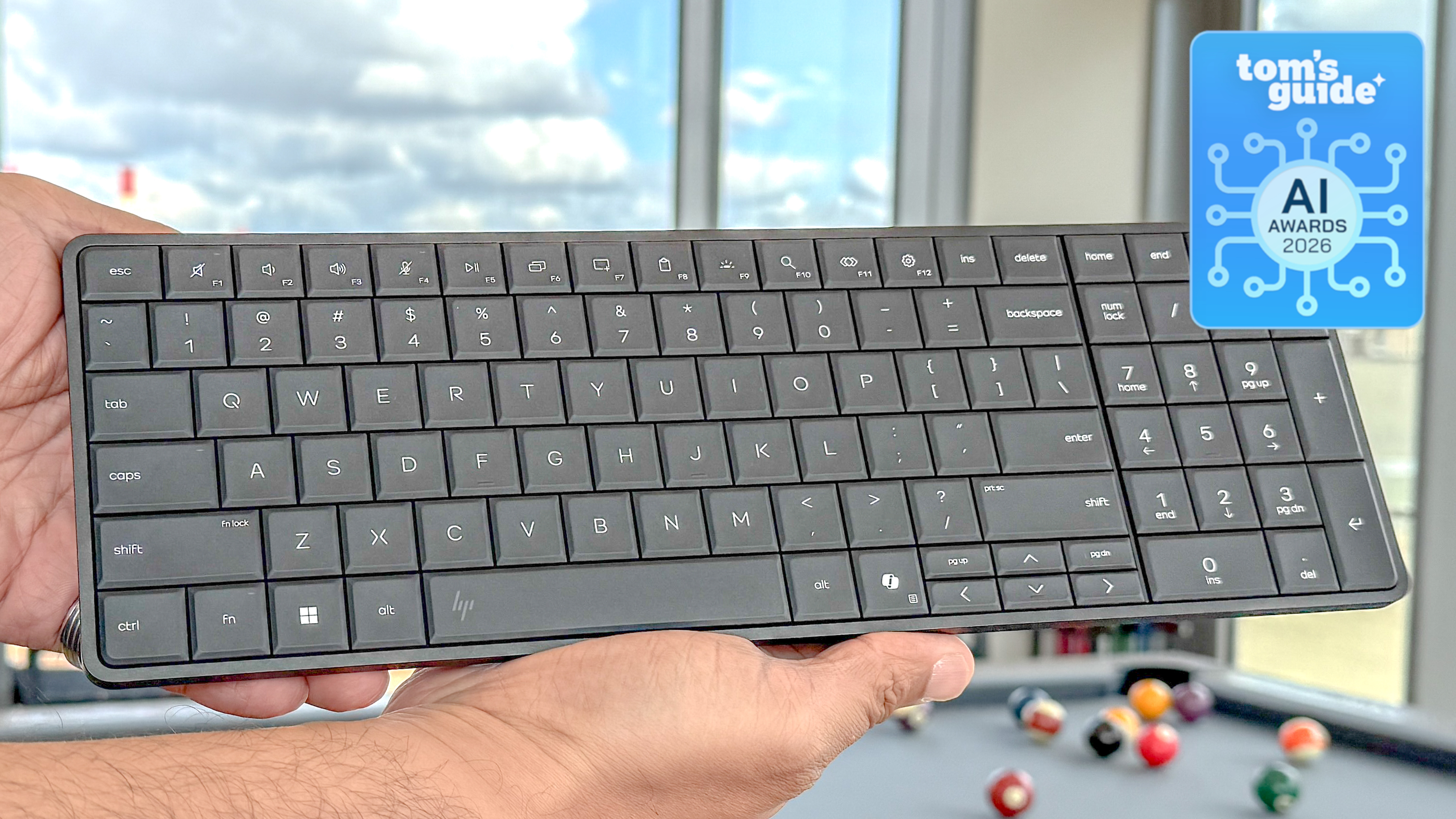 The HP EliteBoard G1a in hand with a Tom's Guide AI Awards 2026 badge