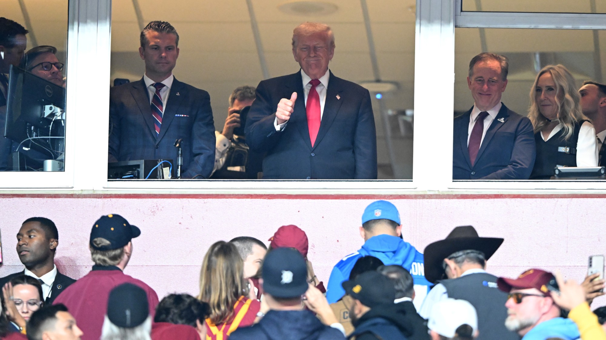 Secretary of Defense Pete Hegseth and President Donald Trump look on during a game between the Detroit Lions and the Washington Commanders at Northwest Stadium in November 2025 in Landover, Maryland. 