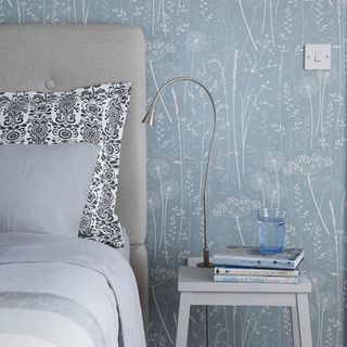 bedroom with wallpaper and books