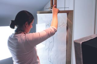 Digitise your artwork: affixing the artwork to the easel to be photographed