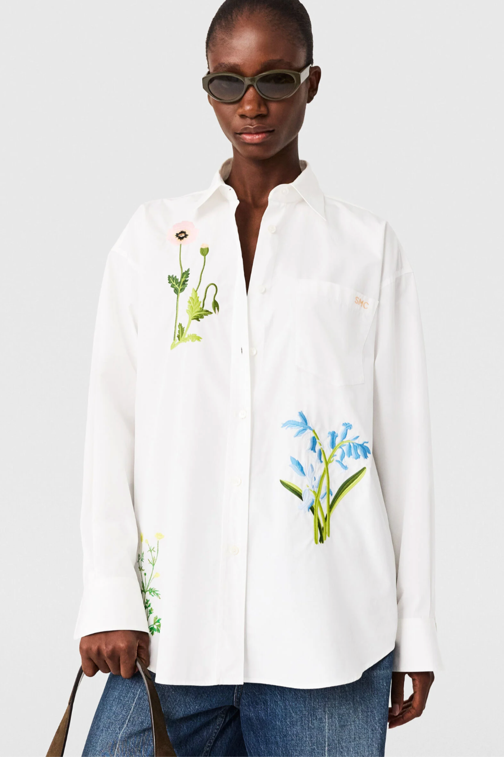 model wears Stella McCartney white cotton shirt floral embroidery