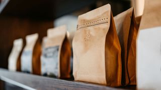 Bags of coffee beans sitting on shelf