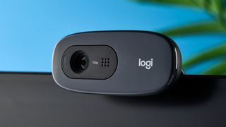 a small, black, oblong-shaped webcam with a universal attachment clip and a logi logo