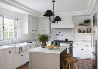 kitchen with white cabinets and island with range cooker and white walls