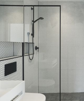 Monochrome modern bathroom with white tiles and black fixtures and fittings