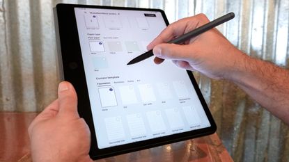 A person using a stylus to select a content template on the TCL Note A1 tablet