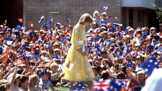 32 of the best Princess Diana Quotes -Diana surrounded by a crowd of children in Australia wearing a yellow dress