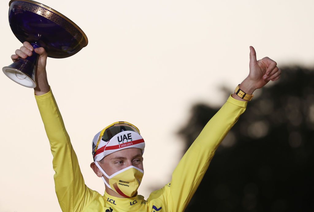 Team UAE Emirates rider Slovenias Tadej Pogacar wearing the overall leaders yellow jersey celebrates on the podium after winning the 107th edition of the Tour de France cycling race after the 21st and last stage of 122 km between ManteslaJolie and Champs Elysees Paris on September 20 2020 Photo by KENZO TRIBOUILLARD AFP Photo by KENZO TRIBOUILLARDAFP via Getty Images