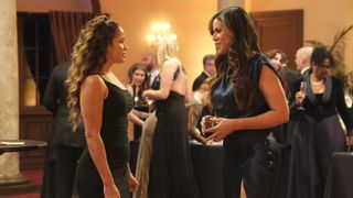 Jaina Lee Ortiz and Merle Dandridge as Andy and Natasha Ross talking at the Firefighters Ball in Station 19 season 6
