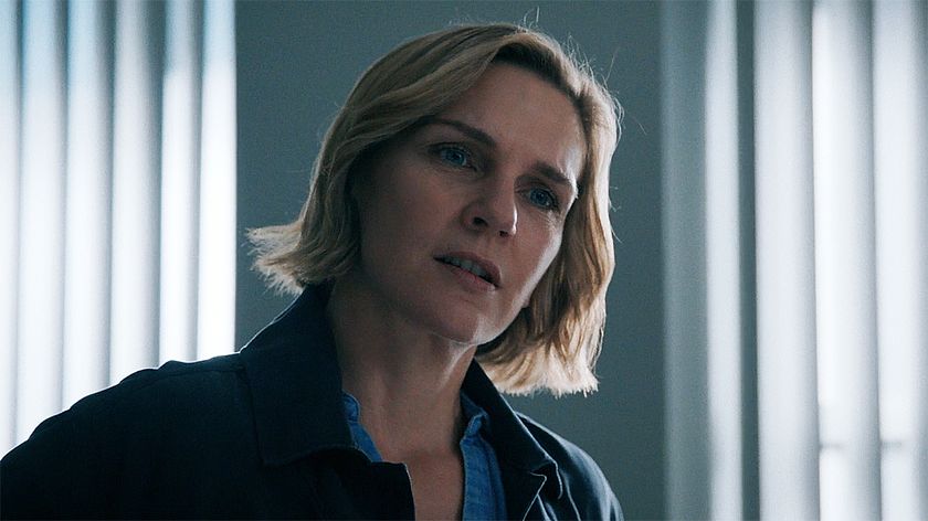 Carol standing up with her head tilted to the left in Pluribus episode 4