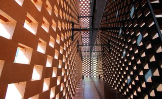 Inside hallway with a brick-patterned façade