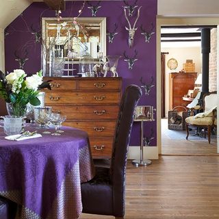 dining room with with wooden flooring and purple wall