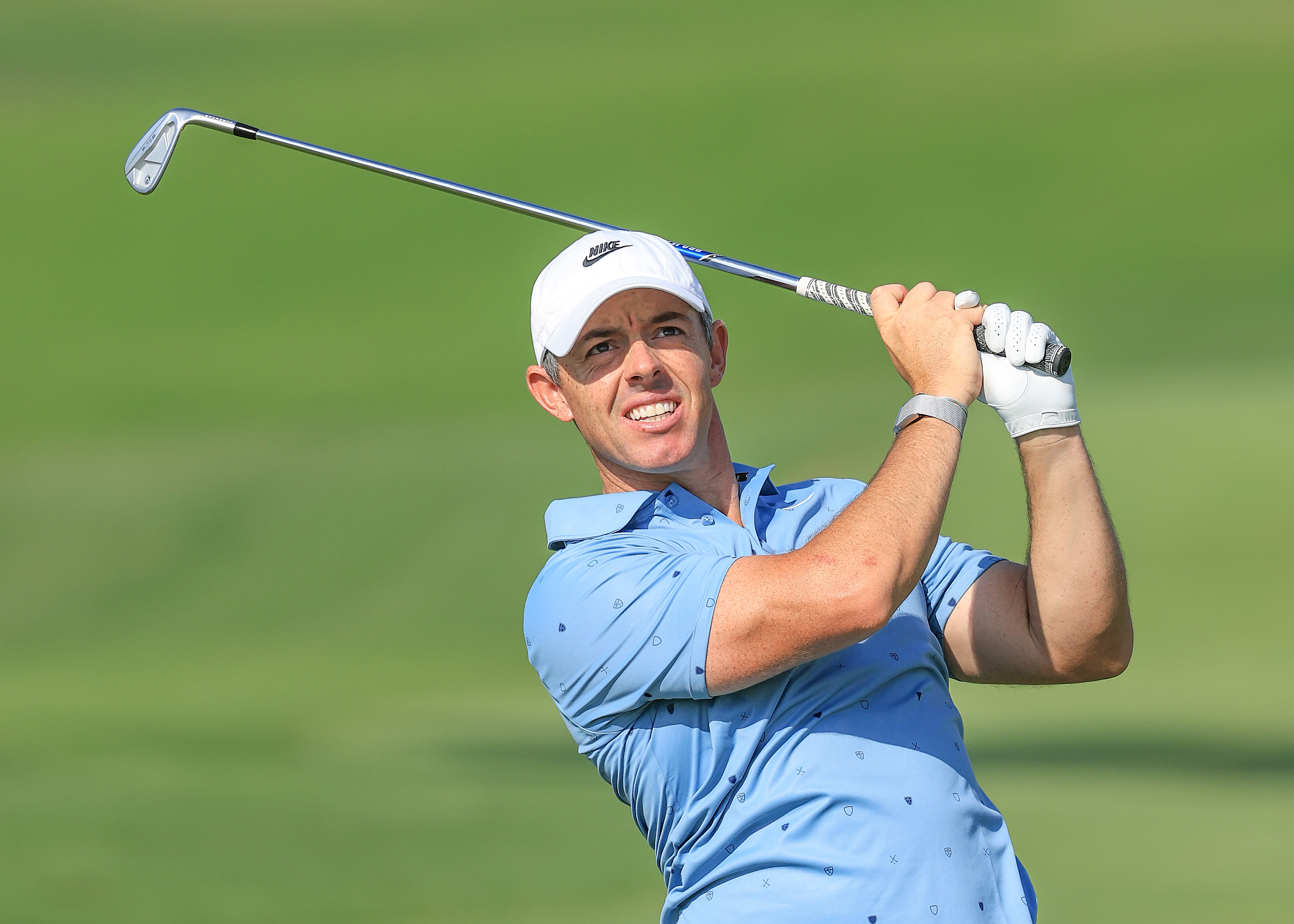 Rory McIlroy hits a shot with an iron and watches its flight