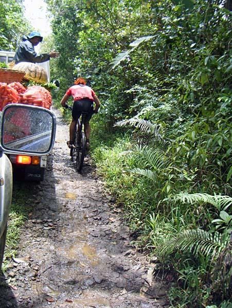 Christophe Gerard passes a truck of vegetables.