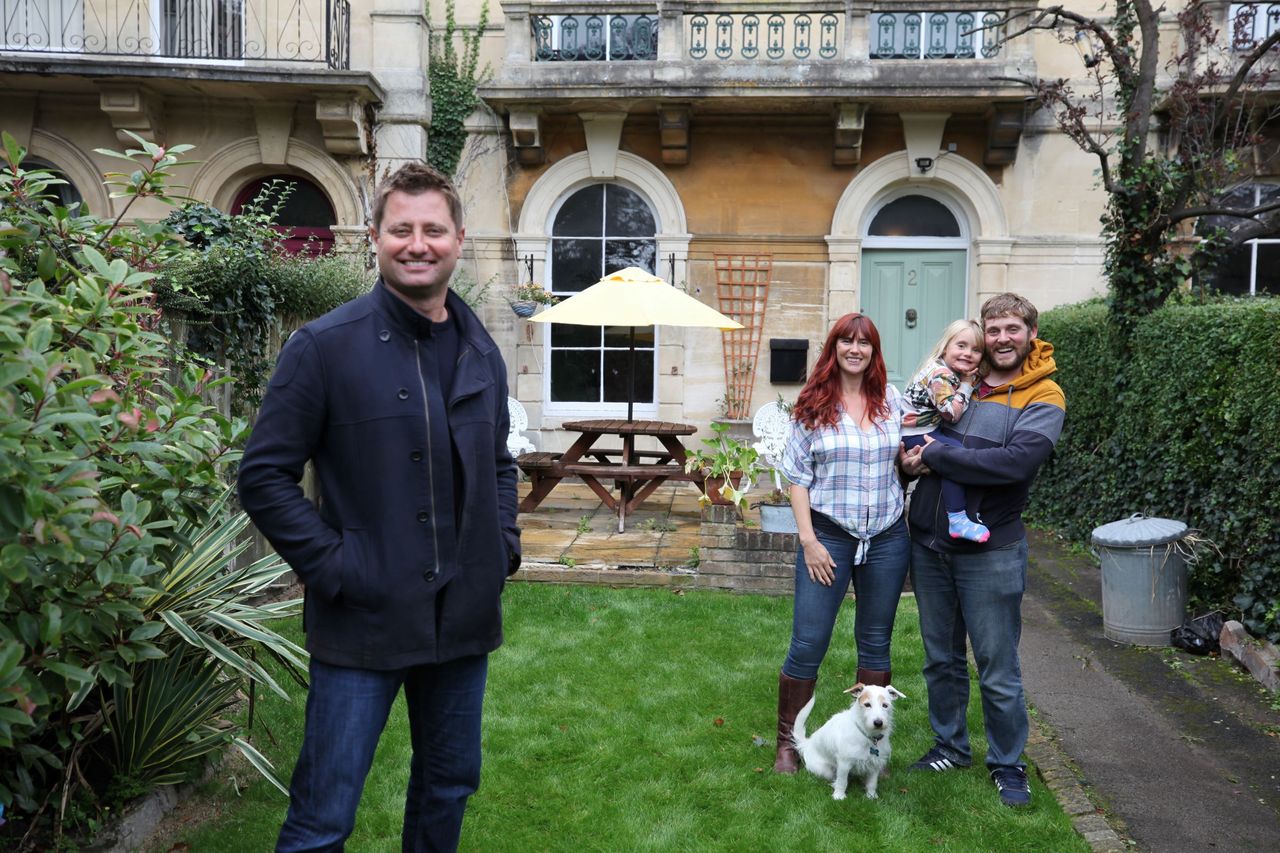 George Clarke and the couple in the back garden with their child and dog