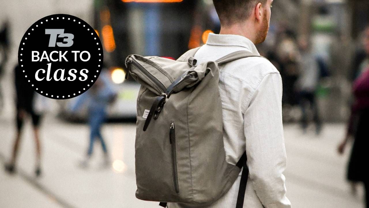 Man commuting to work while wearing a backpack with a T3 Back to Class logo