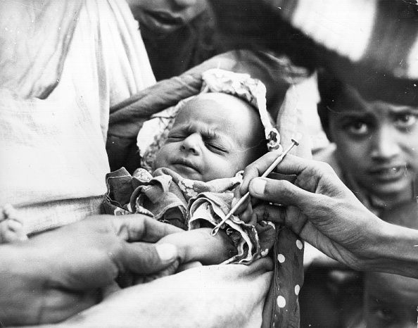 A baby is vaccinated against smallpox in 1962.