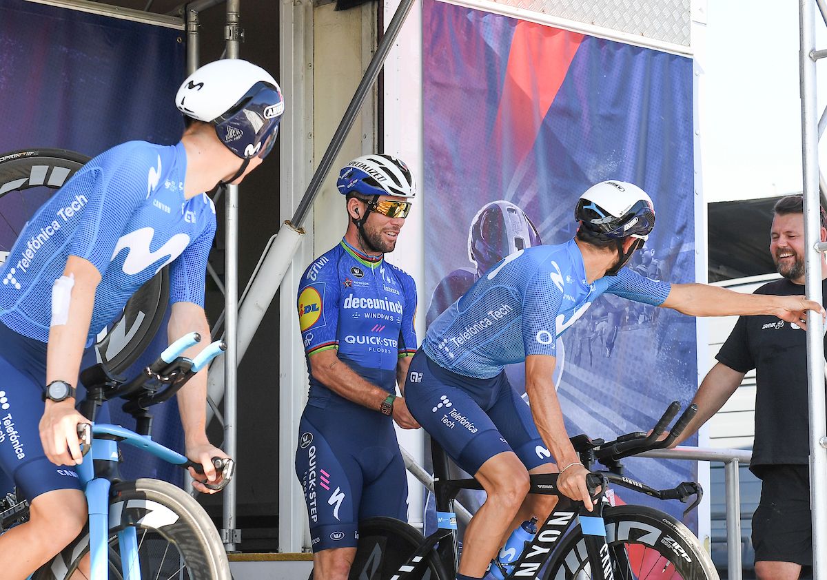 Picture by SWpix.com - 07/09/2021 - Cycling - AJ Bell Tour of Britain Stage 3 - Carmarthenshire Team Time Trial - Llandeilo to National Botanic Garden of Wales, Wales - Deceuninck Quick-Step's Mark Cavendish lending a helping hand to Movistar riders warming up.