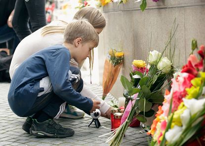 Mourners in Munich the day after an attack which left 10 dead
