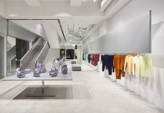 Inside Issey Miyake Ginza Tokyo store with racks of colourful clothes