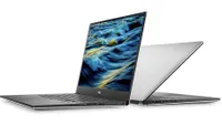 Two Dell XPS 15 laptops back to back with their screens open