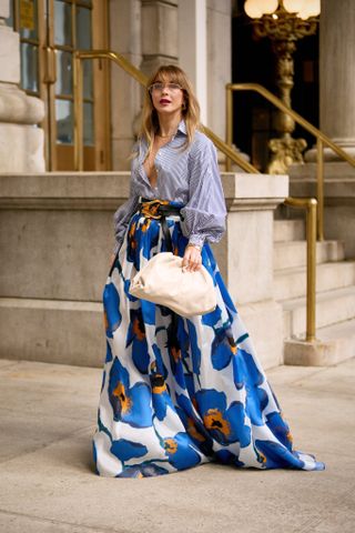 woman in blue floral maxi skirt and striped shirt