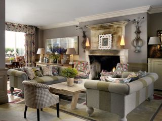 living room with double sofas, open fire, patterned curtains and valance