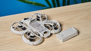 A gray DJI Neo drone with a camera