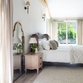neutral bedroom with curtains and bedside table