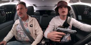 Spree David Arquette and Joe Keery talking while a gun is present