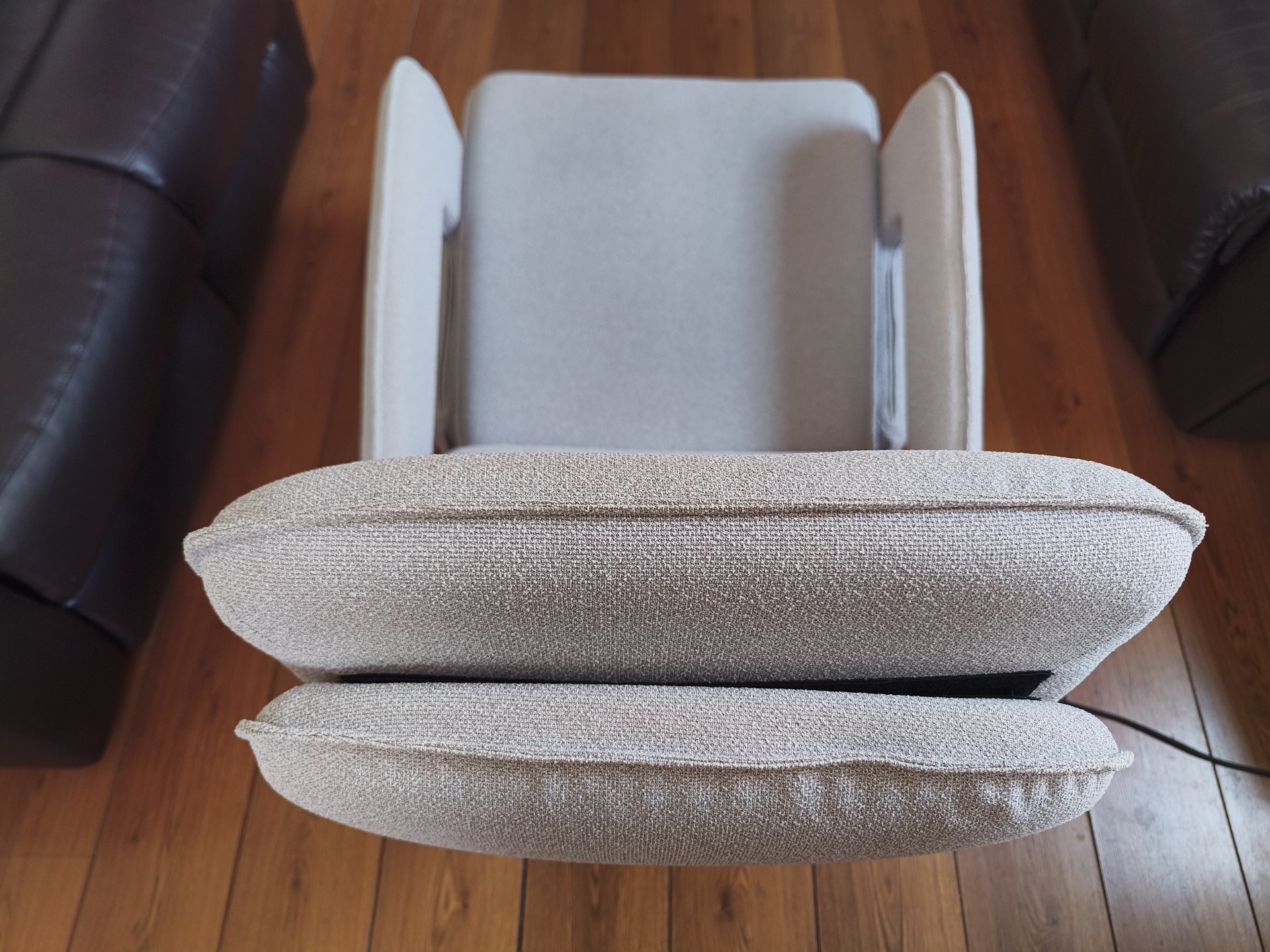 Overhead close-up of the chair's headrest and armrests, showing the texture of the boucl&amp;eacute;-style fabric.