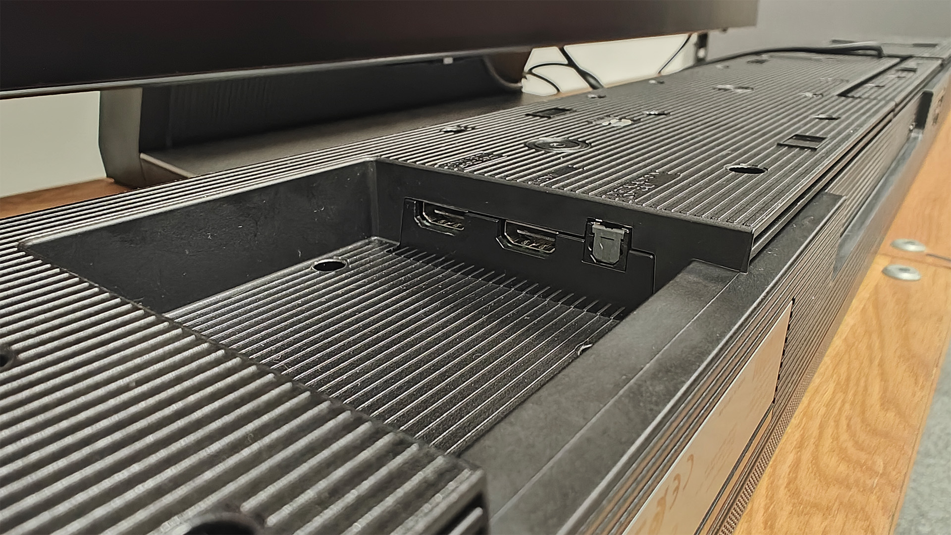 Samsung HW-QS90H Dolby Atmos soundbar, bottom of unit showing connections cove