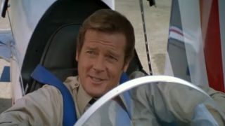 Roger Moore smiles in the cockpit of a minijet in Octopussy.