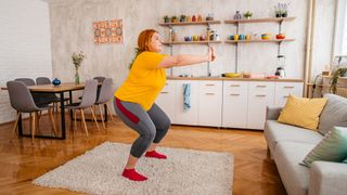 Woman doing squats at home