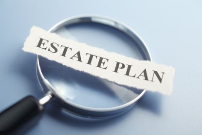 paper that says "estate plan" on magnifying glass