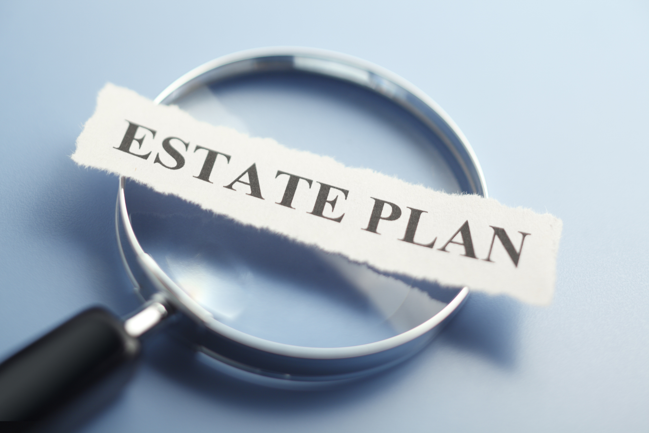 paper that says &quot;estate plan&quot; on magnifying glass