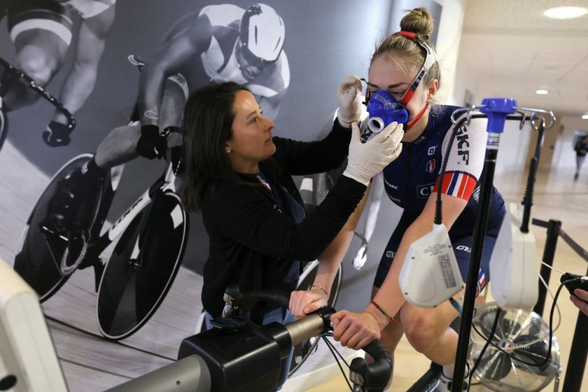 French cyclist Lara Lallemant (R) takes part in a training session with a Cycling Federation sport scientist, French Iris Sachet, as she studies her physiological profile, to feed research on high performance atheletes and prepare the French athletes for the 2024 Olympic Games of in Paris, at the French National Velodrome of Saint-Quentin-en-Yvelines on January 31, 2024. Athlete profiling, 3D scans of the velodrome, twin mannequins, artificial intelligence and marginal gains: French cycling is banking on the hard sciences to shine at the Paris Olympics and take on the Anglo-Saxon pioneers at their own game. (Photo by Thomas SAMSON / AFP)
