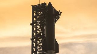 SpaceX's Starship at the launch pad against a yellow clouded sky,