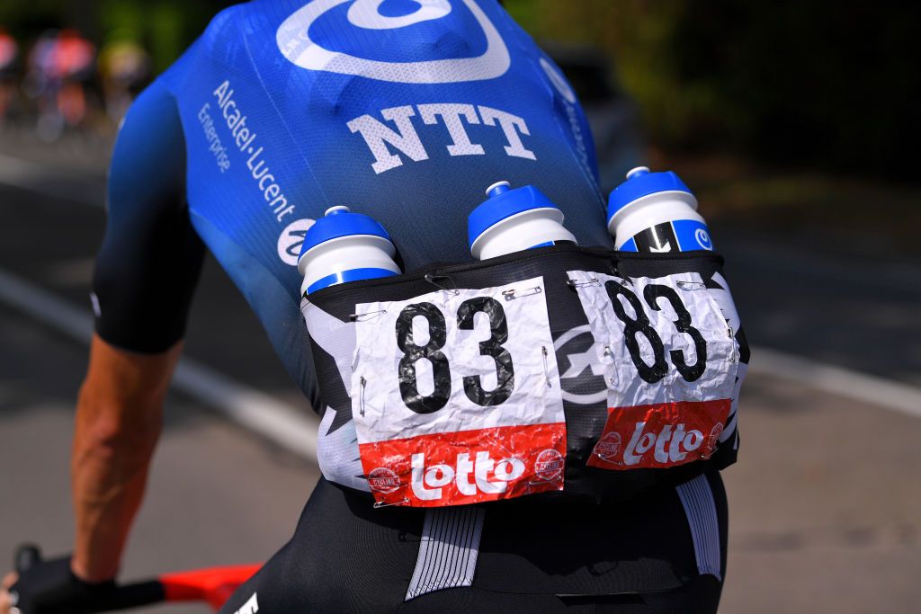 NTT Pro Cycling carrying water bottles