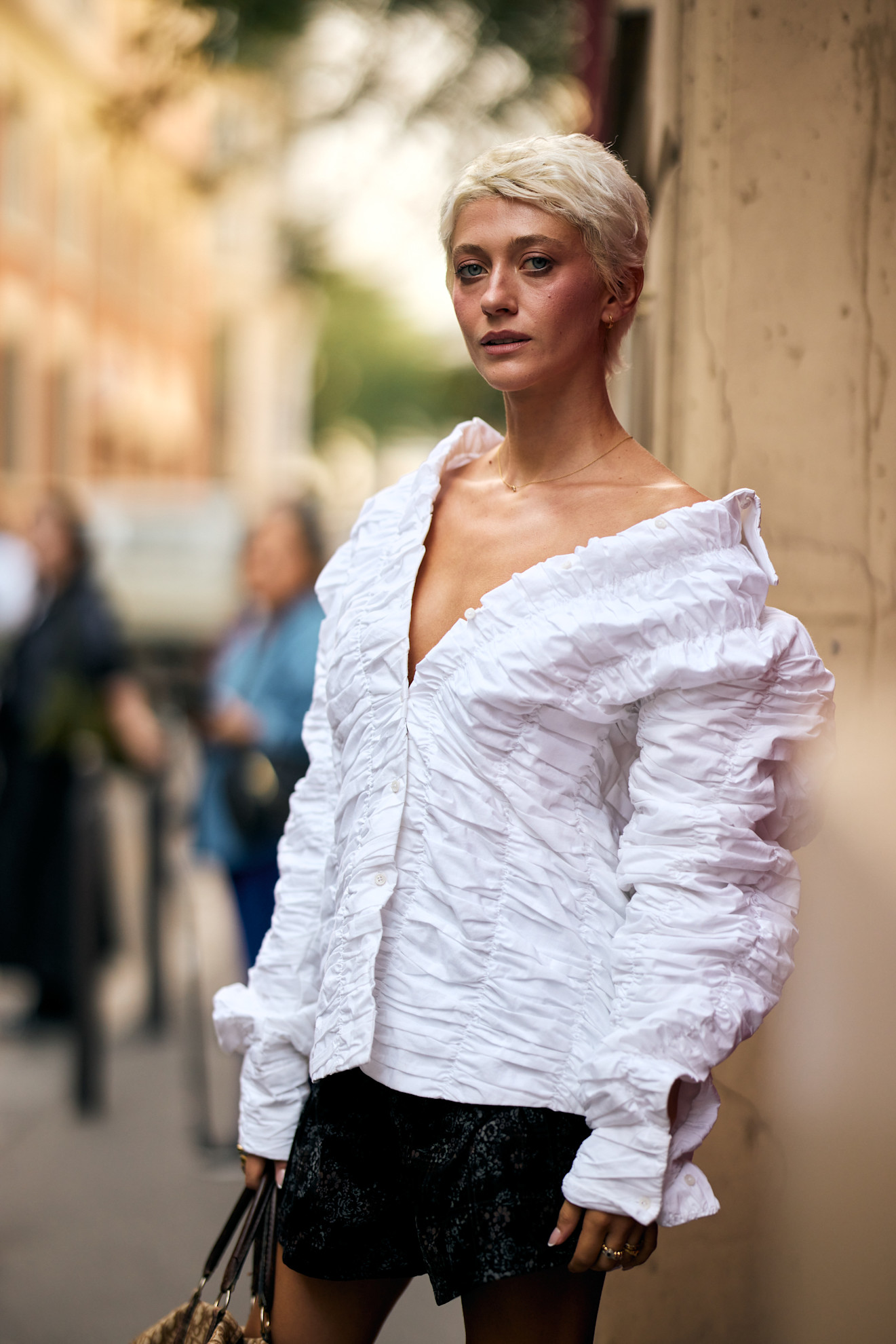 a white woman in a white shirt and black skirt