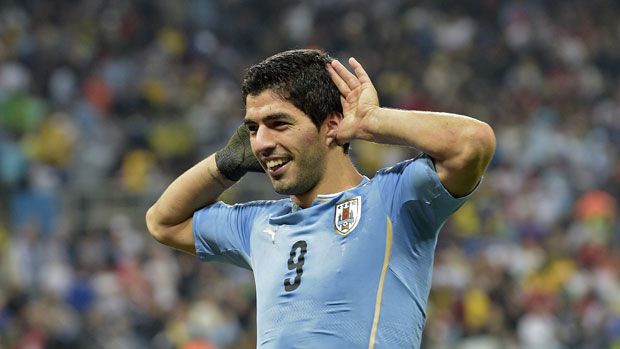 Luis Suarez celebrates after scoring against England