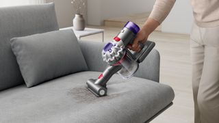 Dyson Car+Boat vacuum cleaner being used on the sofa